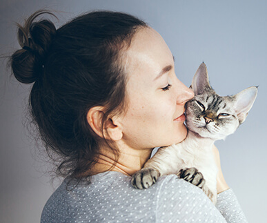 woman snuggling cat